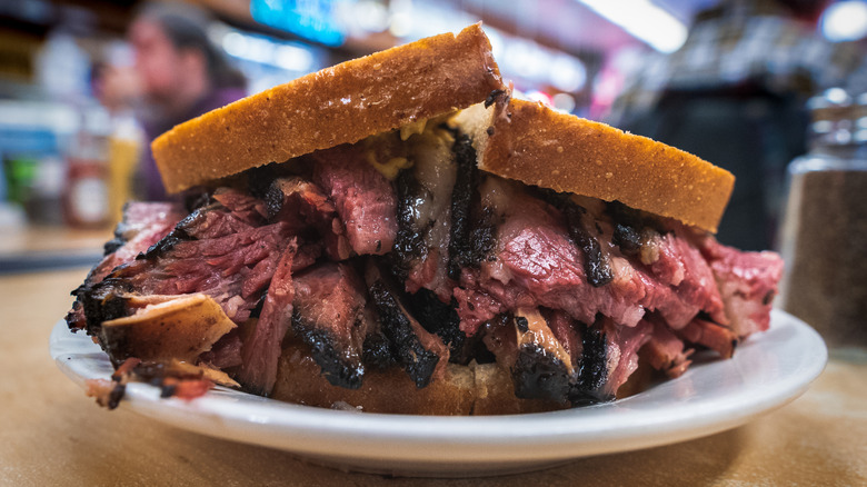 A pastrami sandwich on a plate at a Jewish deli