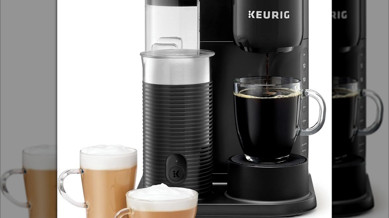 The K-Café Essentials machine with various cups of coffee around it
