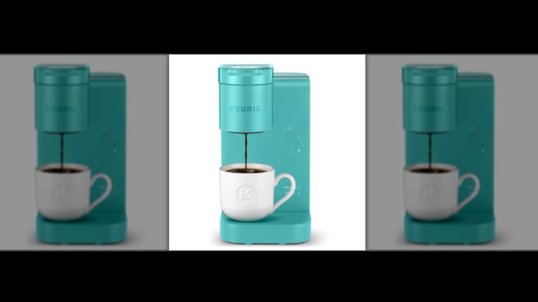 A teal K-Express brewing a coffee