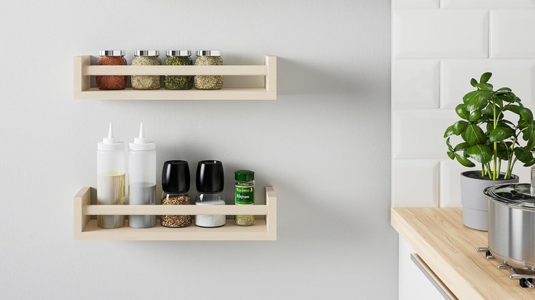 BEKVÄM spice racks mounted on a wall holding kitchen items
