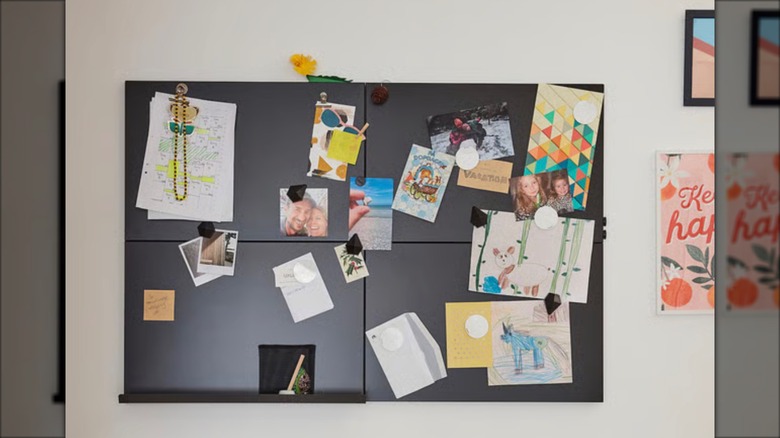SVENSÅS memo board with pictures and papers hanging