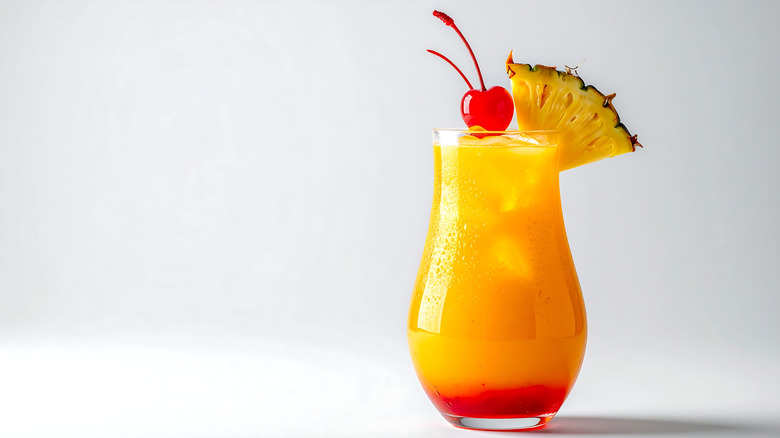 Cherry pineapple cocktail with fresh garnishes