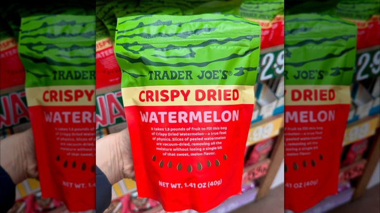A hand holds crispy dried watermelon in bag from Trader Joe's