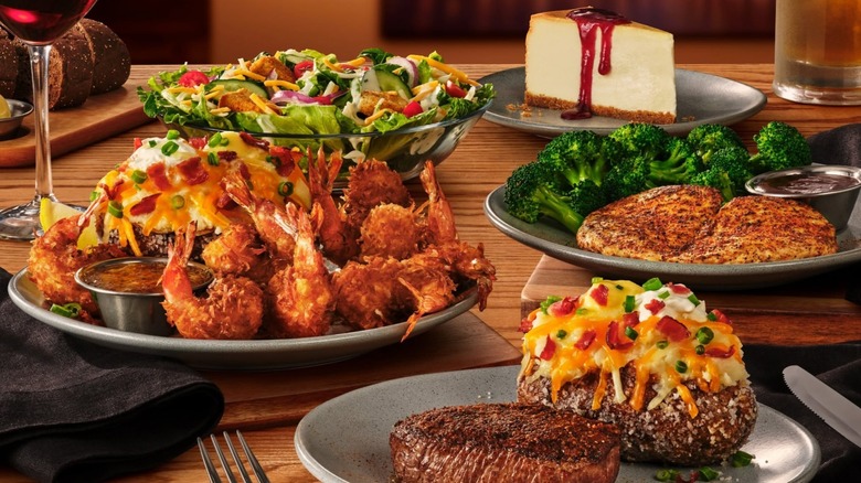 an array of Outback Steakhouse menu items on a table