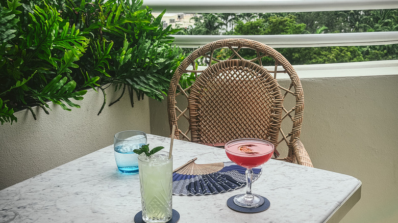Two drinks flutes at Vilebrequin with beach view in background