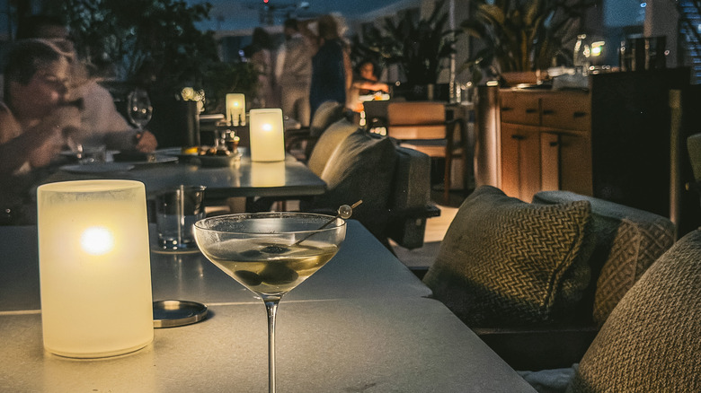 A martini at Seia with rooftop terrace in background