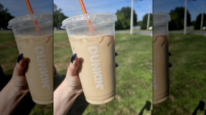 Woman's hand holding a Peanut Butter Dunkalatte