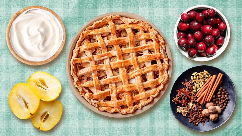 Apple pie with ingredients on gingham surface