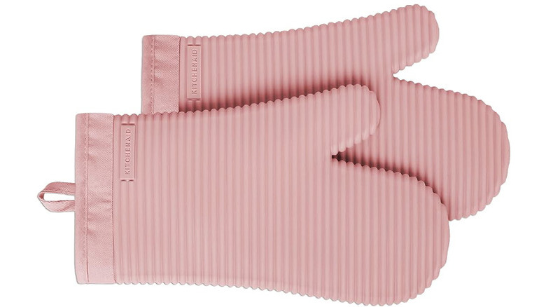A pair of pink KitchenAid Ribbed Silicone Oven Mitts