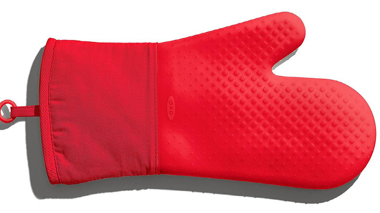 A single red OXO Good Grips oven mitt