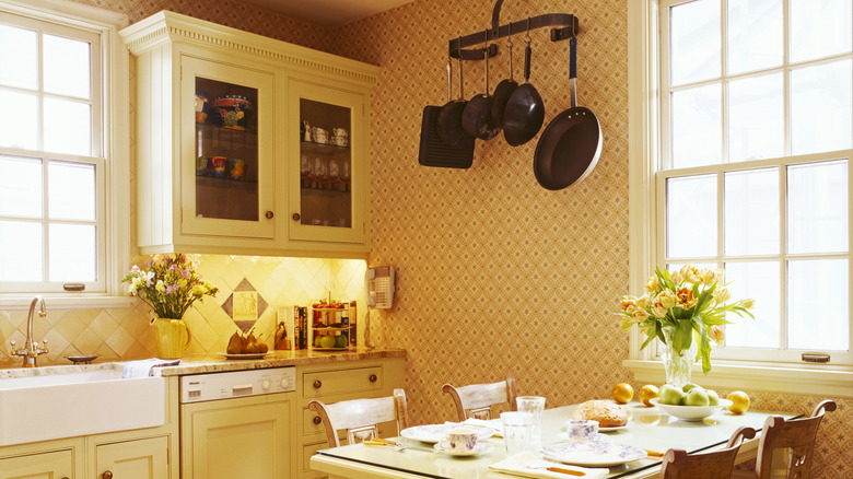 a kitchen with yellow cabinets