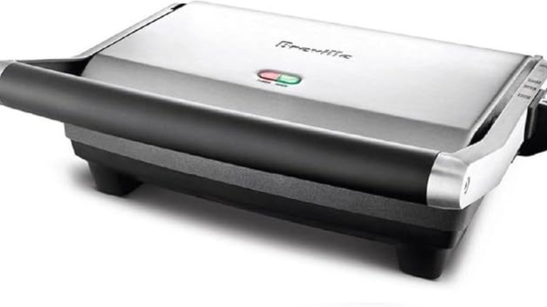 A stainless steel panini press is shown.