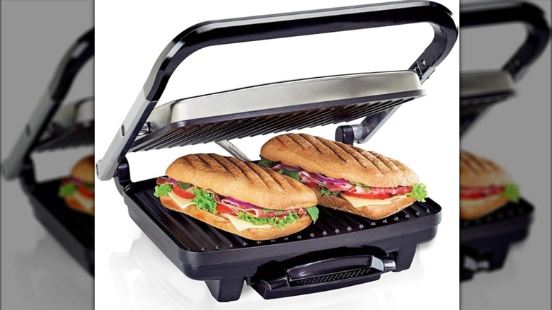 A panini press has two sandwiches on it.