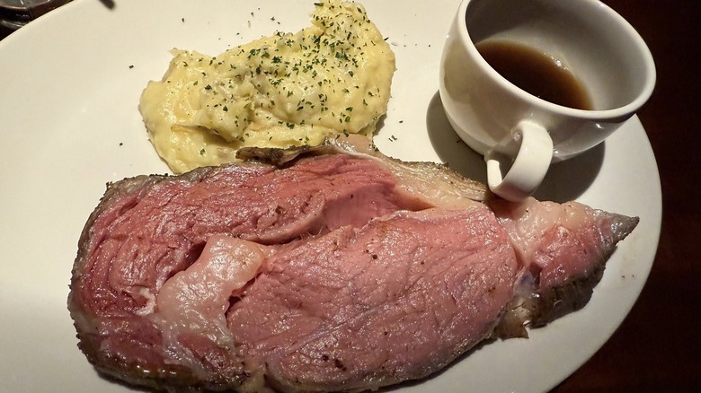 J Alexander's prime rib served with mashed potatoes and au jus dipping sauce