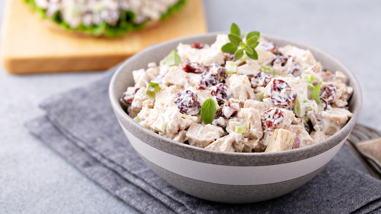 A bowl of chicken salad on a table.