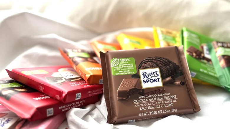 Ritter Sport's milk chocolate with cocoa mousse filling in its package with other varieties in a row behind it.