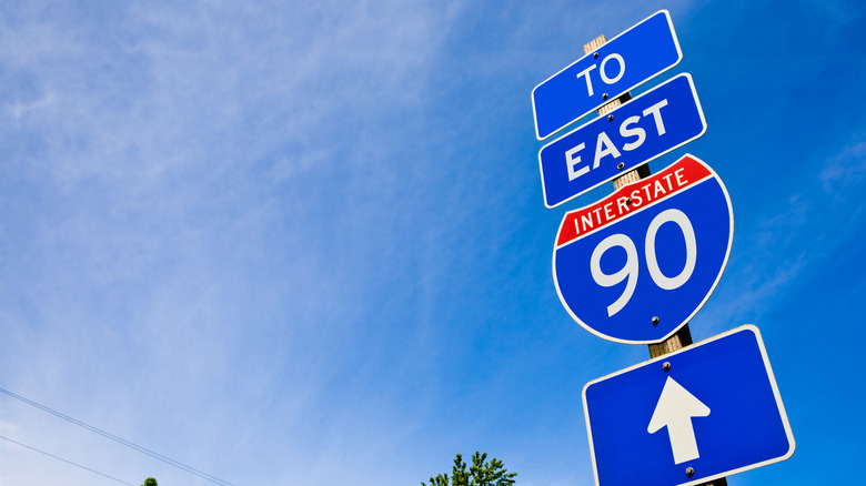 I-90 E sign against a blue sky background