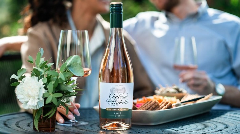 Bottle of Chateau Ste. Michelle Rose at a table with food