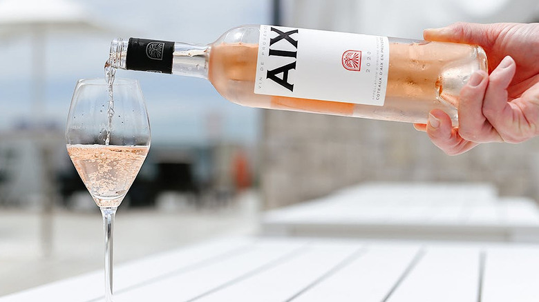 Bottle of Aix Rosé pouring into a glass