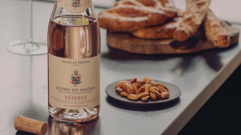 Bottle of Famille Perrin Rosé with plate of nuts