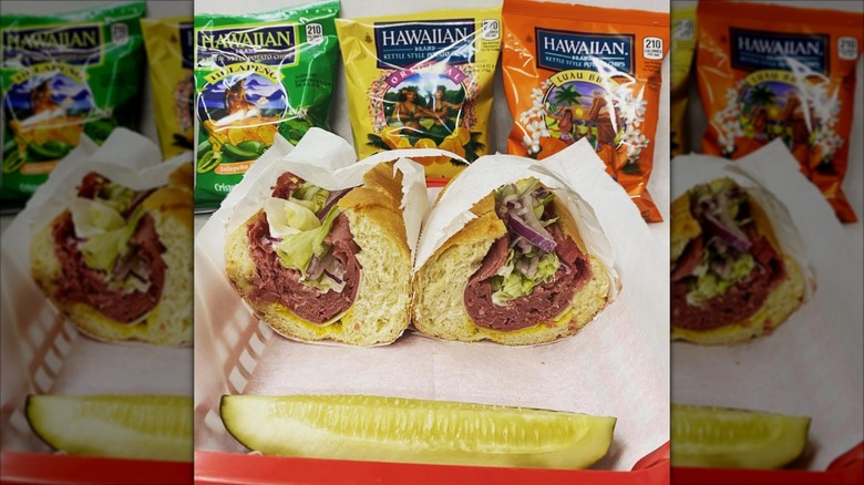 Corned beef subs, bags of chips, and pickle