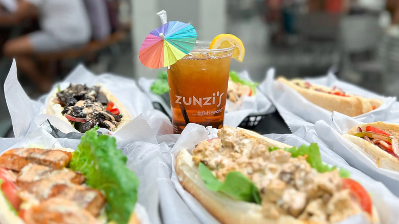An iced drink surrounded by sandwiches