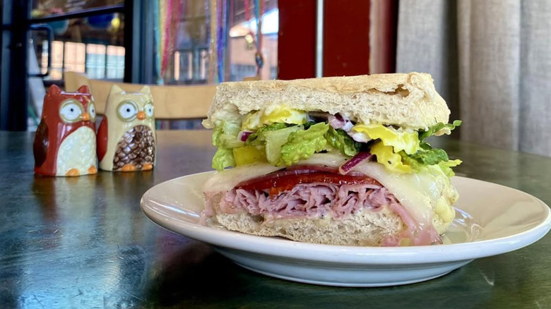 A sandwich on a table with owl decor