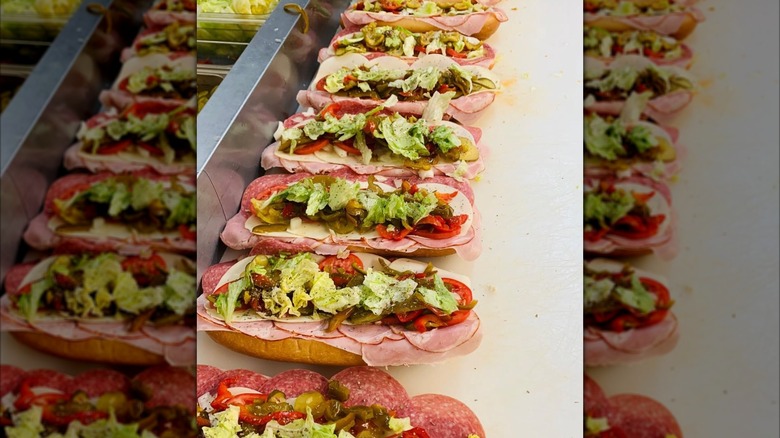 Row of prepared hoagies on counter