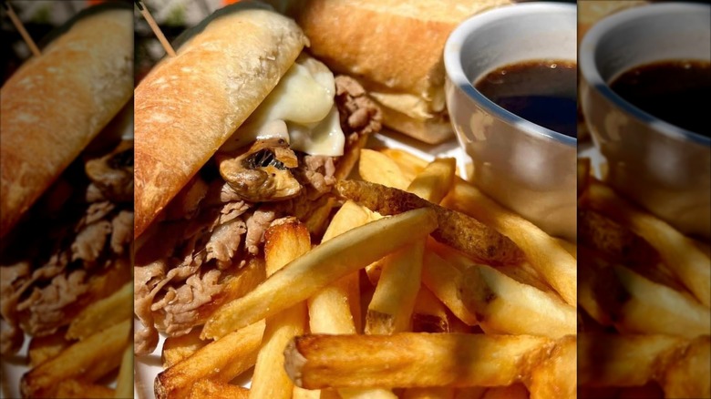 A sandwich, fries, and dipping sauce