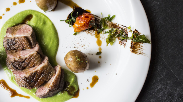 steak with wasabi sauce on plate with potato