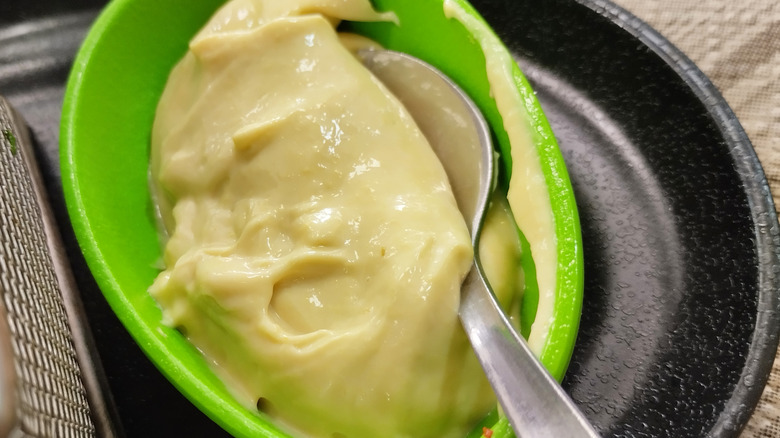 Scoop of wasabi mayo with a metal spoon
