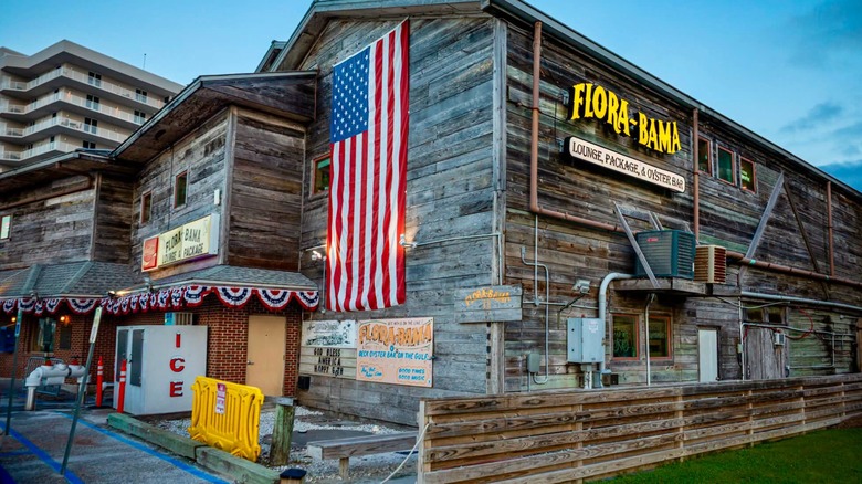 Exterior of Flora-bama wooden building with American flag