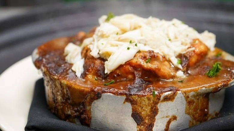 Shrimp and crab stew in overflowing stone bowl