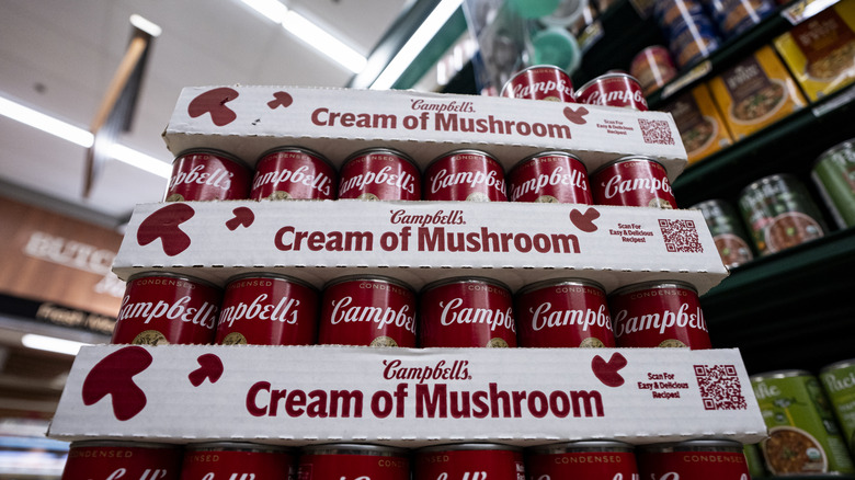 Cans of Campbells' Cream of Mushroom soup in a grocery store.
