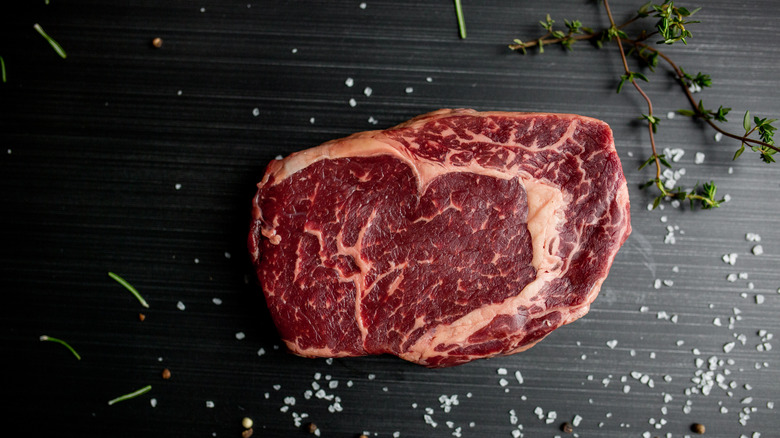 an uncooked ribeye steak