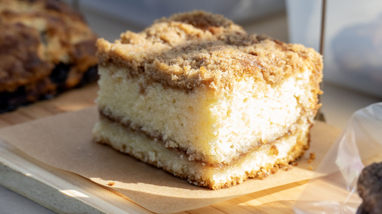 coffee cake cut in a square on a wooden board