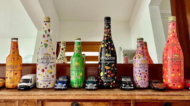 Different flavors of Capriccio Sangria along a wooden mantle