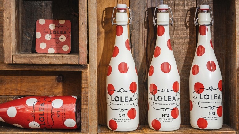 Three bottles of Lolea No 2 Sangria on a wooden shelf