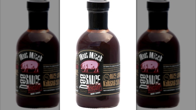 A bottle of Meat Mitch WHOMP! Competition BBQ Sauce on a white background