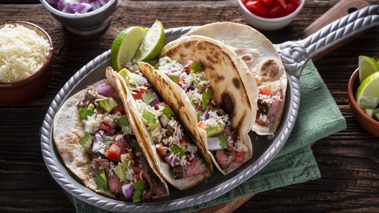 decorative plate with tacos and lime wedges