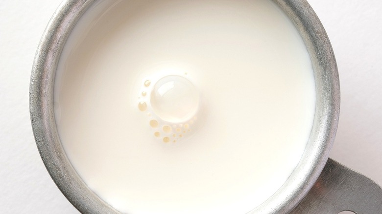 Half-and-half in a silver bowl with handle