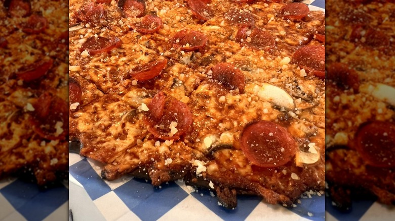 Bungalow by Middle Brow tavern-style pizza on a blue and white checked table