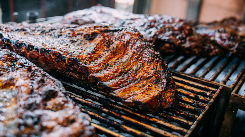 A rack of ribs sits on the grill
