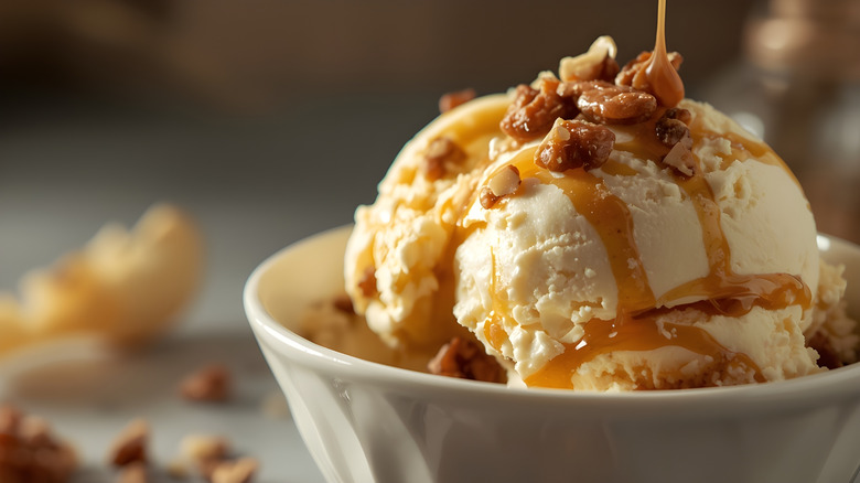 Ultra-Realistic Close-Up of Creamy Vanilla Ice Cream with Caramel Drizzle and Nuts.