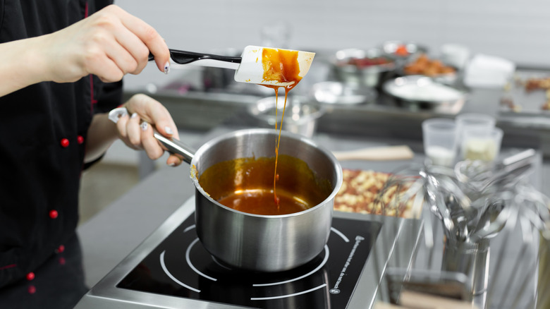 Steel pot with boiling caramel