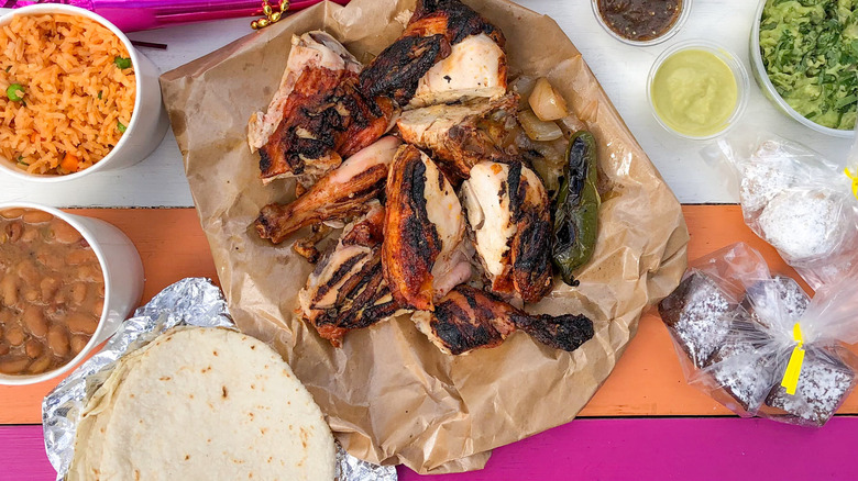 A spread of chicken and side dishes from Fresa's Chicken Al Carbon.