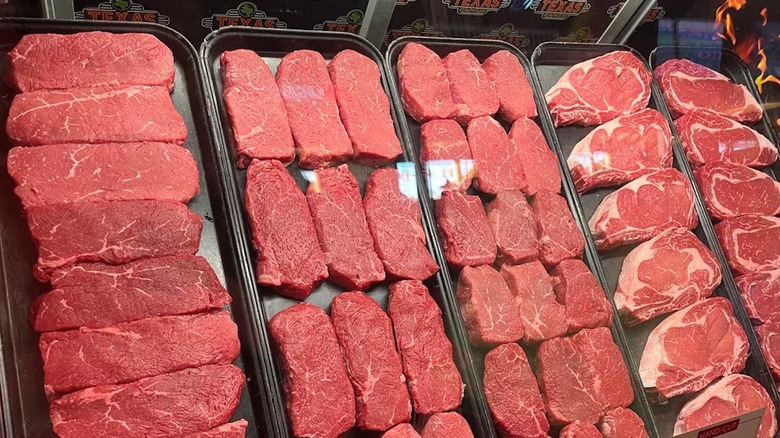 Texas Roadhouse steaks lined up inside a glass container