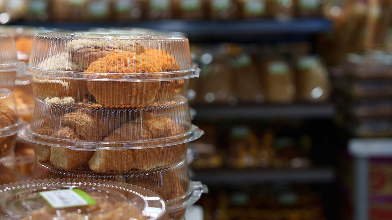 Close-up of packaged muffins and croissants at a grocery store
