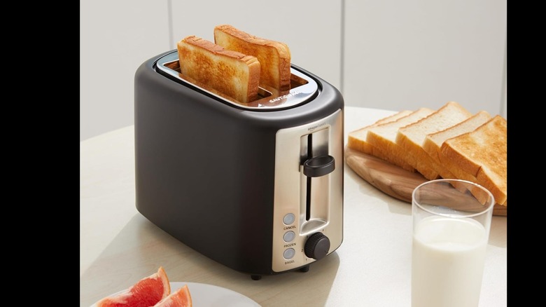 Product image of AmazonBasics Toaster next to bread and milk