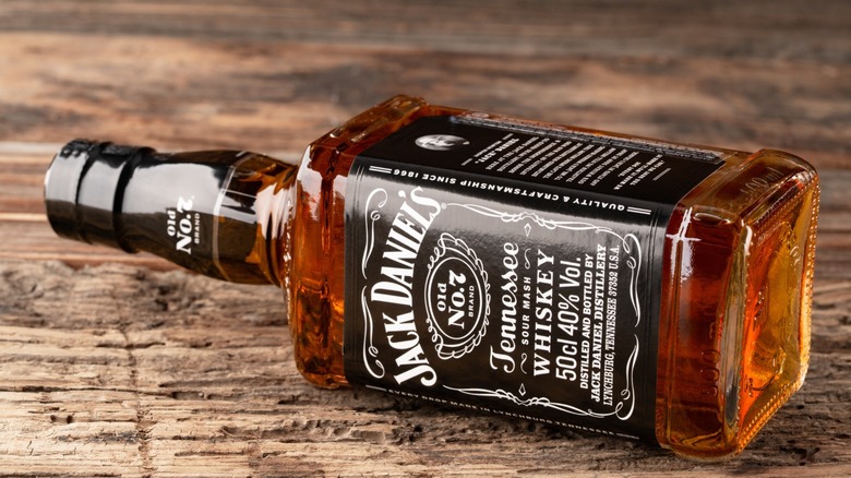 A bottle of Jack Daniels laying on its side.
